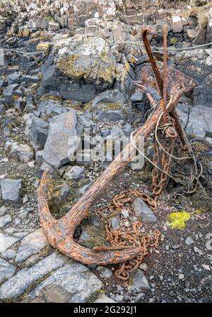 A rusted old anchor at Croig harbour on the Isle of Mull Stock Photo