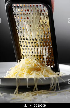 Food prep - Parmesan cheese & grater in a restaurant kitchen Stock Photo -  Alamy