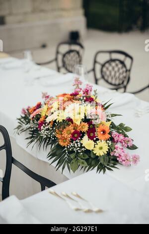 Flower arrangement on a table ready for wedding reception Stock Photo