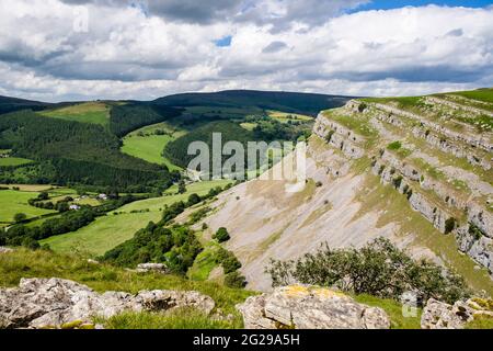 Eglwyseg mountain limestone escarpment above green valley near Llangollen, Denbighshire, North Wales, UK, Britain Stock Photo