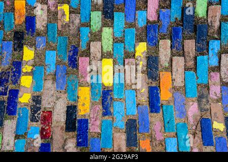 Top view on pieces of multicolored ceramic tiles decorated in garden. Old pavement of tiles textured. Street mosaic cobblestone sidewalk. Abstract,bac Stock Photo