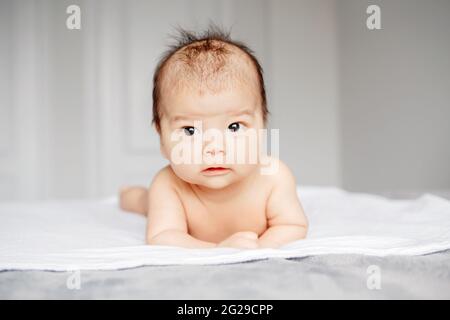 Closeup of adorable aware alert curious Asian Chinese newborn baby Stock Photo