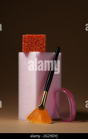 Make up cosmetic sponges and brush on beige background. Modern conceptual cosmetic still life Stock Photo