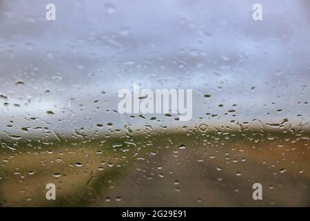 Rain obscuring rural view through a windshield Stock Photo