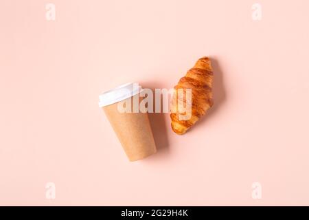 Coffee to go in a paper cup with croissants, top view. Stock Photo