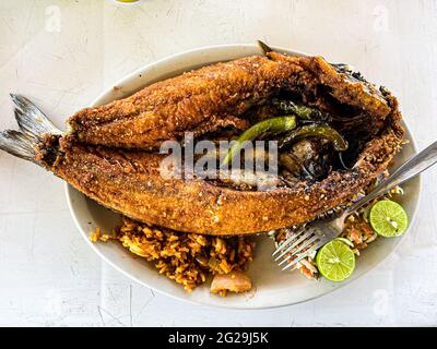 Fried fish. fried smooth fish. Mullet, Flat-headed mullet. Mullet. mullet fish, serrano peppers, lemons,. sea food. Seafood , Food, food, Meals, food. Stock Photo