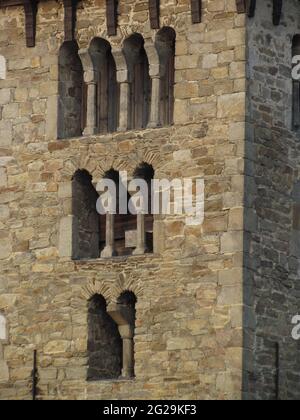 Detail of Romanesque stone masonry with typical arched windows, medieval architecture Czech republic, old tower of the church Stock Photo