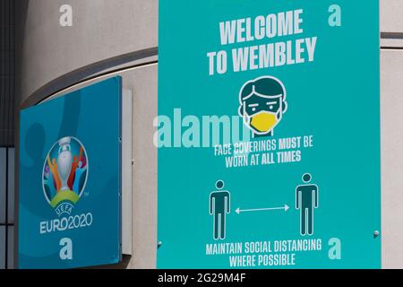 Wembley Stadium, Wembley Park, UK. 9th June 2021.  Signs around Wembley Stadium Concourse reminding fans to wear face coverings ahead of UEFA European Football Championship. Postponed by a year as the Coronavirus pandemic hit worldwide in 2020, the tournament starts on 11th June 2021, with Wembley Stadium hosting it's first match, England v Croatia, on 13th June 2021. Amanda Rose/Alamy Live News Stock Photo