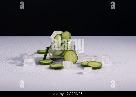 cosmetics cucumber with ice on black and white background. Stock Photo