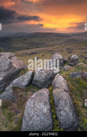 A beautiful sunset at Carhead Rocks in the Peak District. Carhead Rocks is a small gritstone edge that is just below Stanage Edge Stock Photo