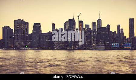Manhattan skyline silhouette at sunset, color toning applied, New York City, USA. Stock Photo