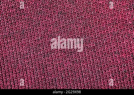 Red fabric texture of natural cotton or linen textile material, warm red sweater cloth close up, high resolution background Stock Photo