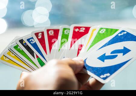 Playing American Card Game Uno, Holding Game Cards in Female Hand