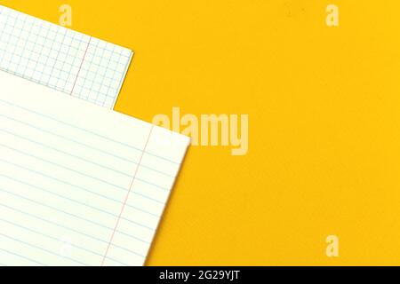 Blank pages of a school notebook close-up on a yellow table desktop background with copy space photo Stock Photo