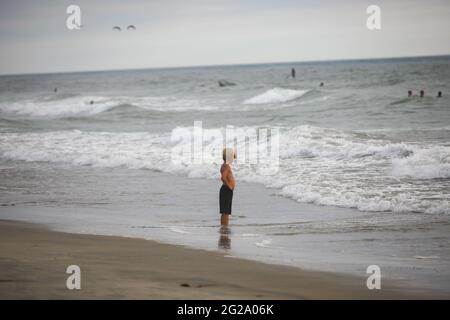 Little boy, enjoying the view during nice peaceful moment at the beach, Del Mar, San Diego, California, USA. June 5th, 2021 Stock Photo