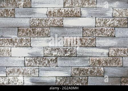 Pastel brick wall. Grey and light brown masonry pattern. Cement block painted texture, grunge architectural element. Abstract backdrop. Building's Stock Photo