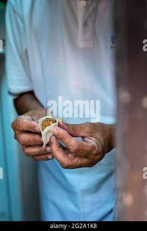 Busy male master fixing modern bike while working in shabby workshop and looking up Stock Photo