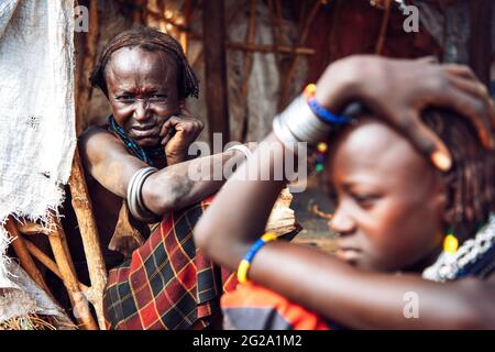 Young and old women from Dassanech tribe in village, Omo valley, Ethiopia Stock Photo