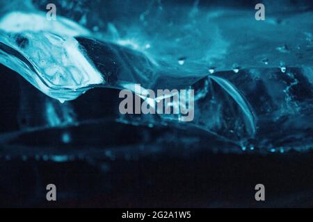 Closeup of glowing transparent blue water sea wave in the ocean in Iceland Stock Photo
