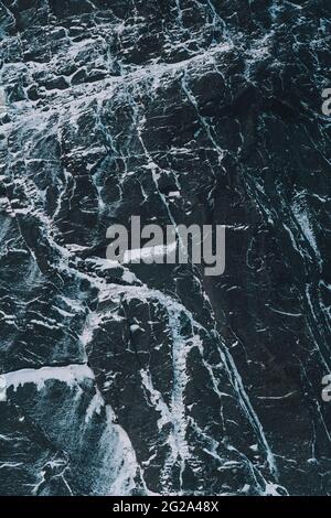 detail of black rock with snow in arctic island Stock Photo