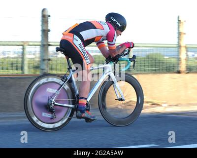 Iwade, Kent, UK. 9th June 2021. Wigmore Cycling Club organised a 10 mile time trial on the new 'Q10/45' course, which runs from Iwade to the Cowstead roundabout on the Isle of Sheppey. Amateur riders pass through the iconic Kingsferry Bridge landmark four times, as they attempt to complete the 10 mile course in the quickest time possible after being set off at intervals. Pictured: riders passing over the Kingsferry Bridge. Credit: James Bell/Alamy Live News Stock Photo