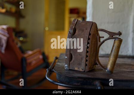Old vintage cast iron ironing in country room on oven Stock Photo