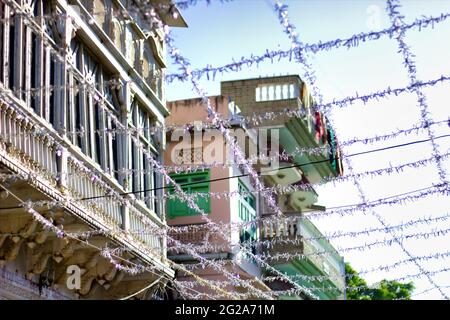 Pushkar, India - November 10, 2016: Low angle shot of Decoration in city of Rajasthan state with silver rope with square tied across the building duri Stock Photo