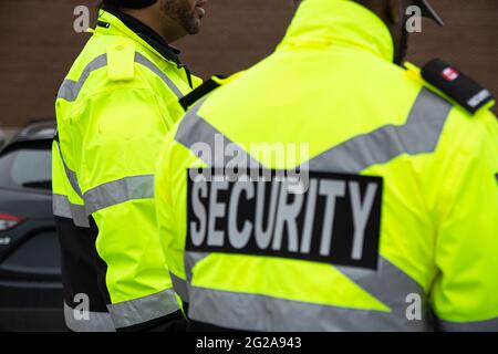 Rear view of parking security watching over the parking area Stock Photo