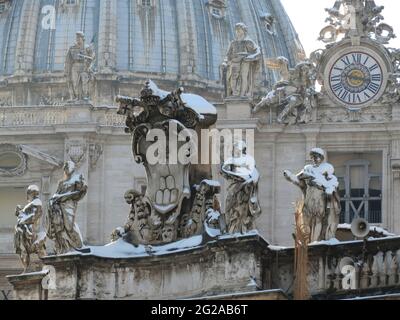 Dome and statues covered with snow in Saint Peter's Place, Rome, Italy Stock Photo