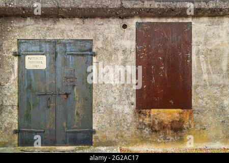 Old battered rusty doors on an abandoned military building in Virginia Stock Photo