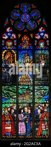 Stained glass-window depicting pilgrimage site of Mariazell in Austria. Votivkirche – Votive Church, Vienna, Austria. Stock Photo