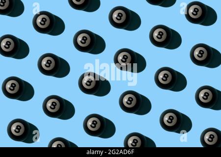 Billiard 8 ball multiplied on soft sky blue background. Shooting pool and playing fun games idea. Minimal sport and recreation concept. Stock Photo