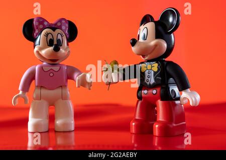 New York, USA - May 25, 2021: A close up shot of a miniature famous Disney character Mickey Mouse Disney character handing over a flower to Minnie Mou Stock Photo