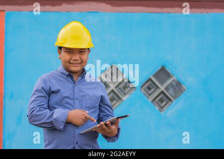 Worker Engineer smile happy in work using tablet technology Stock Photo