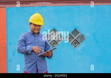 Worker Engineer smile happy in work using tablet technology Stock Photo