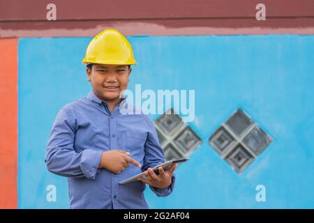 Worker Engineer smile happy in work using tablet technology Stock Photo