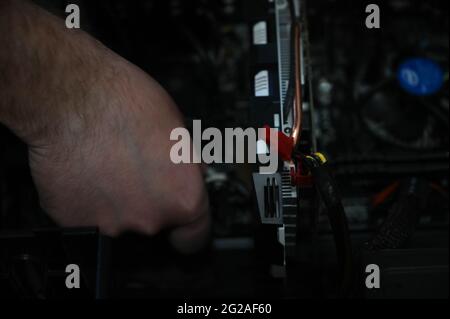 The computer technician installing components into the desktop computer case. Stock Photo