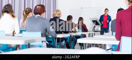 Students with teacher studying in classroom Stock Photo