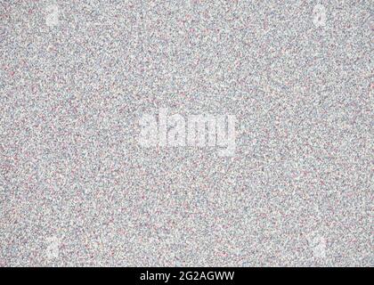 Gray granite with small red, white and black blotches. Background, pattern, texture. Stock Photo