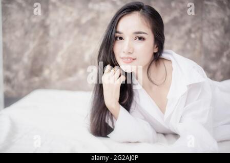 Beautiful asian woman couple sleeping in bed. Morning dream. Attractive girl resting in a comfortable bed on a pillow. Stock Photo
