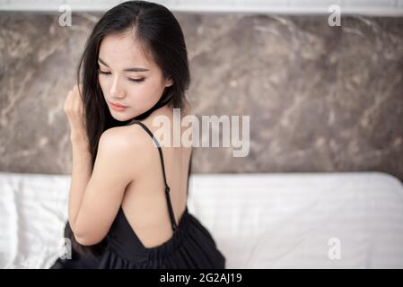 Beautiful asian woman couple sleeping in bed. Morning dream. Attractive girl resting in a comfortable bed on a pillow. Stock Photo