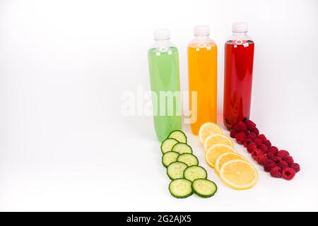Various smoothies or juices in bottles and ingredients on white, healthy diet raw detox vegan clean food concept Stock Photo