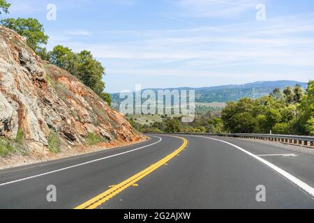 Empty highway going through the Sierra Foothills; Calaveras County, California Stock Photo