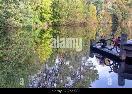 Cyclist by the Ovens River in Porepunkah Stock Photo