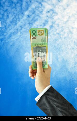 Businessman hand holding money - Australian Dollar Bills Stock Photo