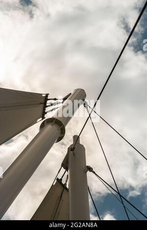 Connection points of tension membrane roof. Turnbuckle wire rope tension for tension membrane roof on a blue sky background. Connections concept and s Stock Photo