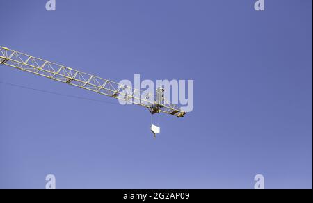 Worker climbed on construction crane, architecture and business, dangerous Stock Photo