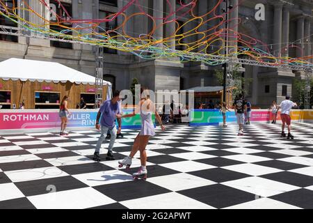 People roller skating at Rothman Roller Rink at Dilworth Park, Philadelphia City Hall, Pennsylvania. Stock Photo