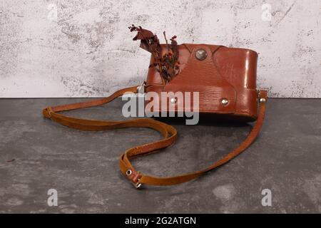 vintage postcard with a retro camera in a leather case Stock Photo