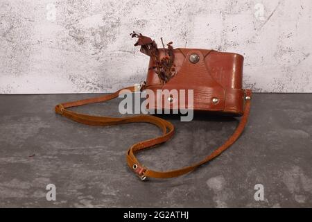 vintage postcard with a retro camera in a leather case Stock Photo